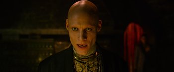 Movie still from “X-Men: Apocalypse” (2016), directed by Bryan Singer – A man with a bald head wearing a necklace; Close Up shot, Low angle