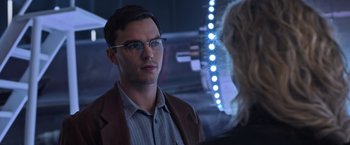 Movie still from “X-Men: Apocalypse” (2016), directed by Bryan Singer – A man wearing glasses and a jacket is talking to a woman in front of him; Close Up shot, Over the shoulder angle