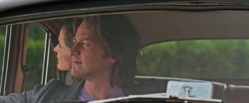 Movie still from “X-Men: Apocalypse” (2016), directed by Bryan Singer – A man sitting in the back seat of a car looking out the window; Close Up shot, Low angle