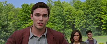 Movie still from “X-Men: Apocalypse” (2016), directed by Bryan Singer – A man and a woman standing next to each other in front of trees; Close Up shot, Over the shoulder angle