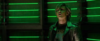 Movie still from “X-Men: Apocalypse” (2016), directed by Bryan Singer – A man in a black shirt and a green jacket; Close Up shot, Low angle