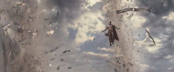 Movie still from “X-Men: Apocalypse” (2016), directed by Bryan Singer – A man flying through the air while holding a kite; Extreme Wide shot, Low angle