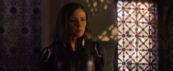 Movie still from “X-Men: Apocalypse” (2016), directed by Bryan Singer – A woman in a black outfit standing next to a window; Close Up shot, Over the shoulder angle