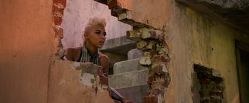 Movie still from “X-Men: Apocalypse” (2016), directed by Bryan Singer – A woman with blonde hair looking up at a wall; Close Up shot, Low angle