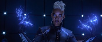 Movie still from “X-Men: Apocalypse” (2016), directed by Bryan Singer – A woman in a black outfit with blue eyes and white hair; Close Up shot, Low angle
