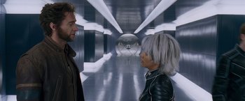 Movie still from “X-Men: The Last Stand” (2006), directed by Brett Ratner – A man and a woman standing next to each other in a hallway; Medium shot, Low angle