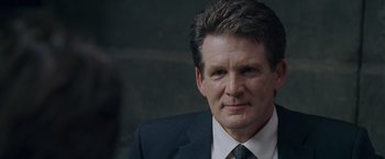 Movie still from “X-Men: The Last Stand” (2006), directed by Brett Ratner – A person wearing a suit and tie; Close Up shot, Over the shoulder angle