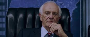 Movie still from “X-Men: The Last Stand” (2006), directed by Brett Ratner – An older man sitting in a chair with his hand under his chin; Close Up shot, Low angle