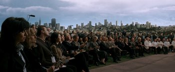 Movie still from “X-Men: The Last Stand” (2006), directed by Brett Ratner – A group of people sitting in front of a city skyline; Extreme Wide shot, High angle