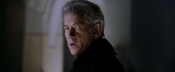 Movie still from “X-Men: The Last Stand” (2006), directed by Brett Ratner – An older man in a black jacket looking at the camera; Close Up shot, Low angle