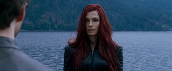 Movie still from “X-Men: The Last Stand” (2006), directed by Brett Ratner – A woman with long red hair standing in front of a body of water; Close Up shot, Low angle