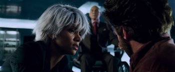 Movie still from “X-Men: The Last Stand” (2006), directed by Brett Ratner – A woman with white hair sitting next to two men; Close Up shot, Over the shoulder angle