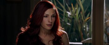 Movie still from “X-Men: The Last Stand” (2006), directed by Brett Ratner – A woman with long red hair sitting in a room; Close Up shot, Over the shoulder angle