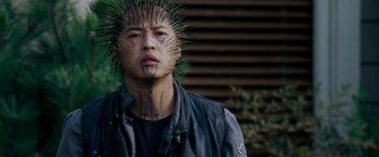 Movie still from “X-Men: The Last Stand” (2006), directed by Brett Ratner – A man with a spiked head tattoo on his face; Close Up shot, Low angle