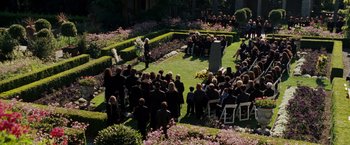Movie still from “X-Men: The Last Stand” (2006), directed by Brett Ratner – A crowd of people sitting in the grass at an outdoor funeral; Extreme Wide shot, High angle