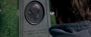 Movie still from “X-Men: The Last Stand” (2006), directed by Brett Ratner – A man looking at a plaque with a picture of a man's head; Close Up shot, Over the shoulder angle