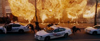 Movie still from “X-Men: The Last Stand” (2006), directed by Brett Ratner – A police car parked on the side of the road; Extreme Wide shot, High angle