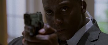 Movie still from “X2” (2003), directed by Bryan Singer – A person holding a gun; Close Up shot, Low angle