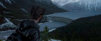Movie still from “X2” (2003), directed by Bryan Singer – A man standing on top of a mountain looking at a lake; Extreme Wide shot, Over the shoulder angle