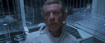 Movie still from “X2” (2003), directed by Bryan Singer – An older man in a white shirt looking at the camera; Close Up shot, High angle