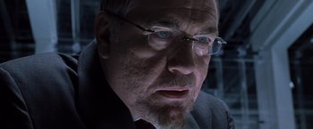Movie still from “X2” (2003), directed by Bryan Singer – An older man wearing glasses and wearing a suit; Close Up shot, Over the shoulder angle