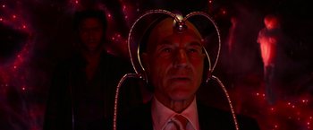 Movie still from “X2” (2003), directed by Bryan Singer – An older man wearing a suit and tie with lights on his head; Close Up shot, Low angle