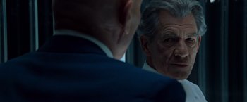 Movie still from “X2” (2003), directed by Bryan Singer – A man in a blue suit is looking at himself in the mirror; Close Up shot, Over the shoulder angle