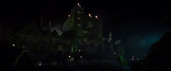 Movie still from “X2” (2003), directed by Bryan Singer – A large building lit up at night with lights on it; Extreme Wide shot, Low angle