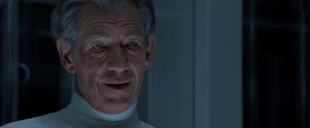 Movie still from “X2” (2003), directed by Bryan Singer – An older man wearing a white shirt and a white collar; Close Up shot, Low angle