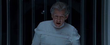 Movie still from “X2” (2003), directed by Bryan Singer – An old man wearing a white shirt and a neck brace; Close Up shot, Low angle