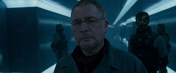 Movie still from “X2” (2003), directed by Bryan Singer – A person wearing glasses in a room; Close Up shot, Low angle