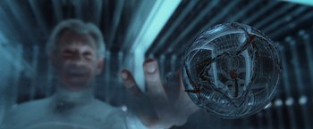 Movie still from “X2” (2003), directed by Bryan Singer – A person holding a glass ball in front of a wall; Extreme Close Up shot, Overhead angle