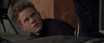Movie still from “X2” (2003), directed by Bryan Singer – A man laying on a bed looking at the camera; Close Up shot, Over the shoulder angle