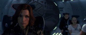 Movie still from “X2” (2003), directed by Bryan Singer – A person sitting in a chair in a room; Close Up shot, Over the shoulder angle