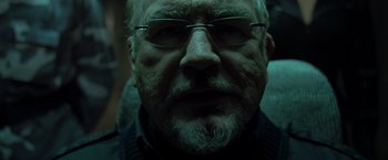 Movie still from “X2” (2003), directed by Bryan Singer – An older man with a beard wearing glasses; Close Up shot, Low angle
