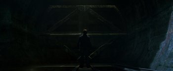 Movie still from “X2” (2003), directed by Bryan Singer – A man standing in front of an opening in a building; Wide shot, Low angle