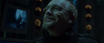 Movie still from “X2” (2003), directed by Bryan Singer – A person wearing glasses and looking up; Close Up shot, Low angle