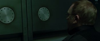Movie still from “X2” (2003), directed by Bryan Singer – An older man looking at a clock on a wall; Close Up shot, Low angle