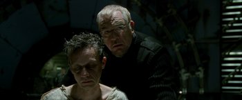 Movie still from “X2” (2003), directed by Bryan Singer – A man standing next to another man in a room; Close Up shot, Low angle