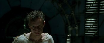 Movie still from “X2” (2003), directed by Bryan Singer – A man in a white t - shirt is looking at the camera; Close Up shot, Low angle