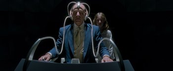 Movie still from “X2” (2003), directed by Bryan Singer – An older man and a young woman in a suit and tie; Medium shot, Low angle