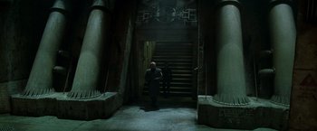 Movie still from “X2” (2003), directed by Bryan Singer – A man walking down a set of stairs in the dark; Wide shot, High angle