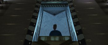 Movie still from “X2” (2003), directed by Bryan Singer – A man standing inside of a building looking up at the sky; Wide shot, Overhead angle
