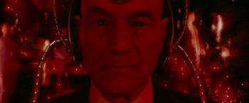 Movie still from “X2” (2003), directed by Bryan Singer – A man's face in red light; Close Up shot, Overhead angle