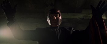 Movie still from “X2” (2003), directed by Bryan Singer – A man wearing a helmet in a dark room; Close Up shot, Low angle