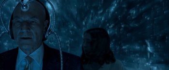 Movie still from “X2” (2003), directed by Bryan Singer – A woman in a white shirt is in a dark room; Close Up shot, Over the shoulder angle