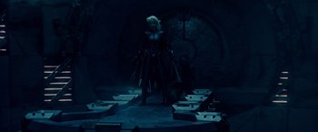 Movie still from “X2” (2003), directed by Bryan Singer – A woman standing in front of boxes in a dark room; Wide shot, Over the shoulder angle