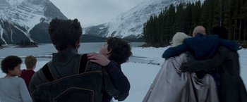 Movie still from “X2” (2003), directed by Bryan Singer – A young boy is hugging his father in the snow; Medium shot, Over the shoulder angle