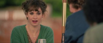 Movie still from “Yesterday” (2019), directed by Danny Boyle – A woman sitting at a table with a glass of wine; Close Up shot, Over the shoulder angle