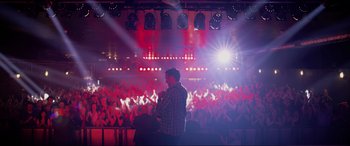 Movie still from “Yesterday” (2019), directed by Danny Boyle – A man standing in front of a crowd of people; Wide shot, High angle